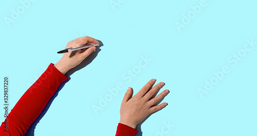 Person writing something with a pen from above