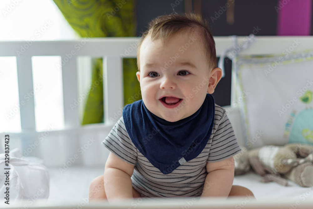 Small, smiling baby sitting