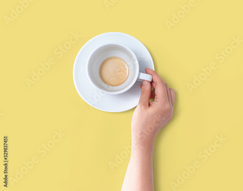 Female hand holding a tea cup overhead view - flat lay