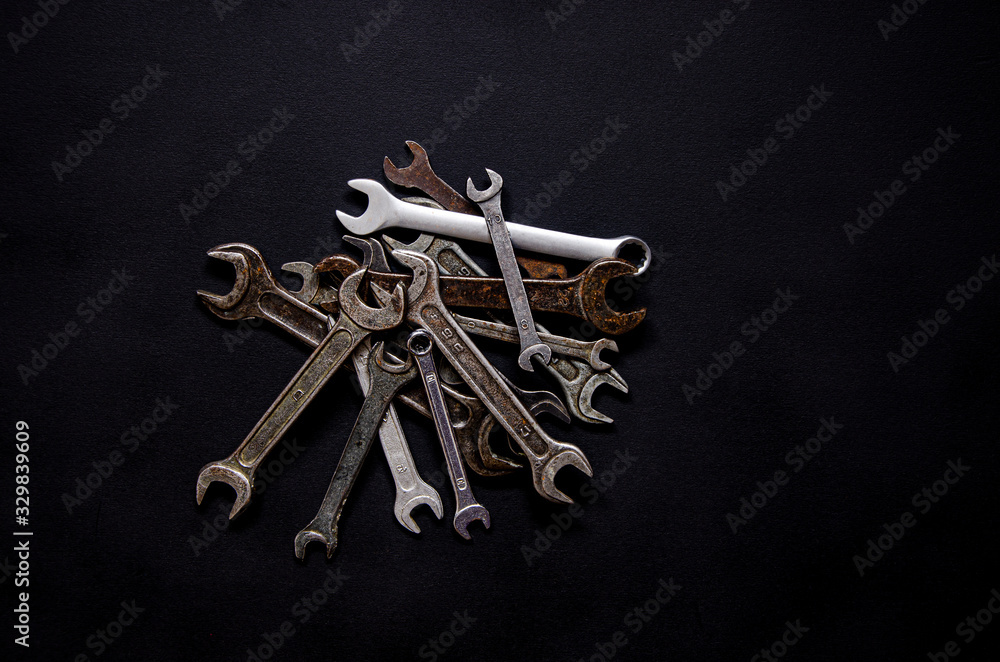 A set of repair tools in a leather case on a black background A set of repair tools in a leather case on a black background