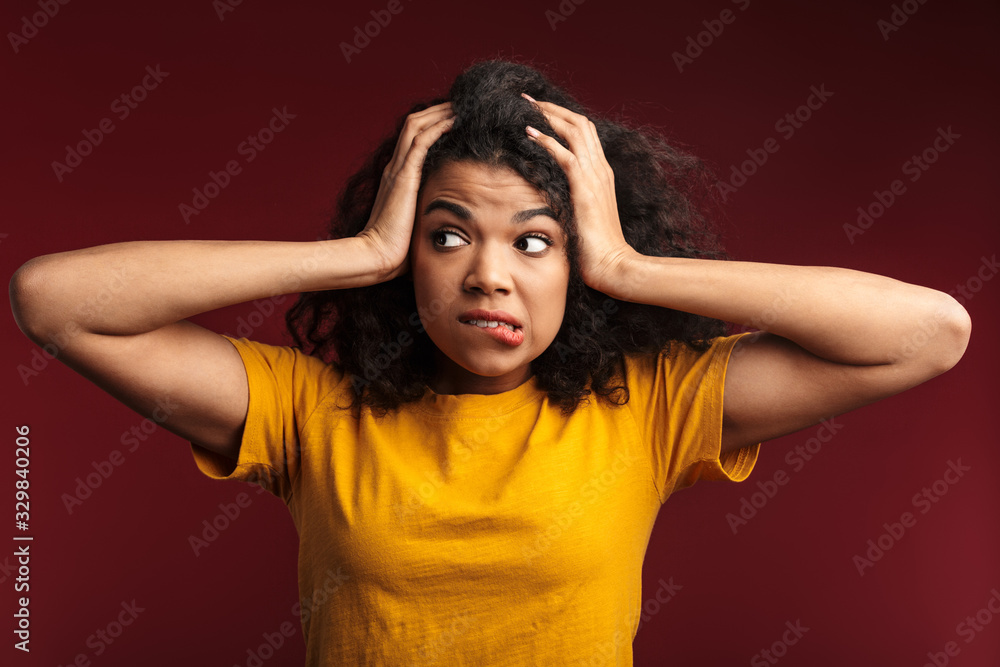 Image of nervous african american woman grabbing her head in panic Image of nervous african american woman grabbing her head in panic