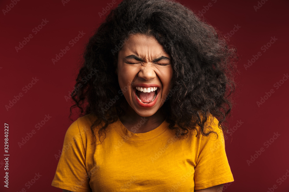 Image of disappointed african american woman with curly hair screaming Image of disappointed african american woman with curly hair screaming