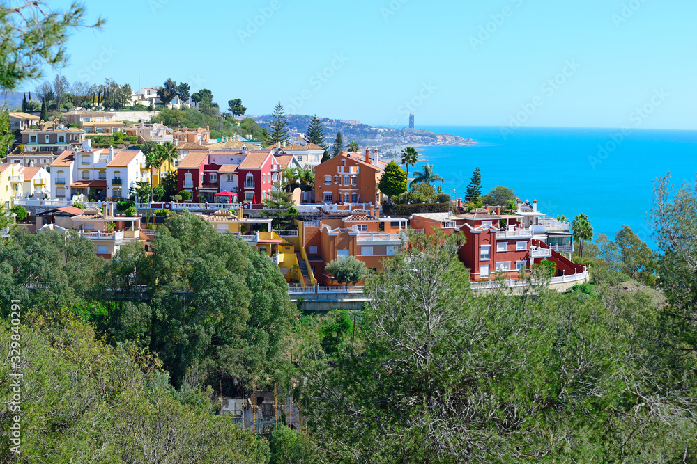 Malaga, Spain - March 4, 2020: Buildings of the city of Malaga next to the Mediterranean Sea.