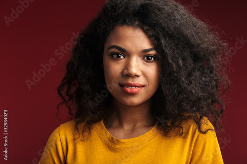 Image of beautiful brunette african american woman with curly hair smiling