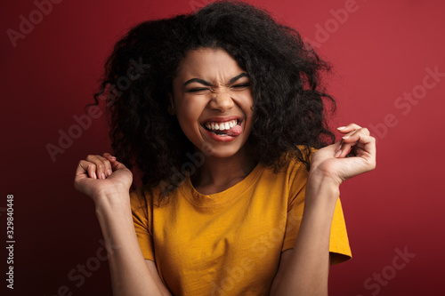 Image of african american woman laughing and sticking out her tongue