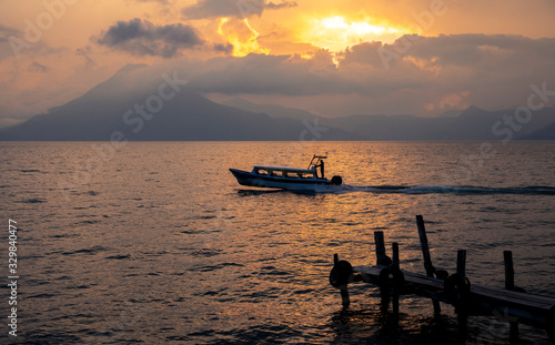 bot traveling on lake Atitlan, Guatemala at sunset 