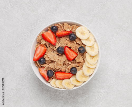 Konstfotografi Multigrain wholewheat healthy cereals with banana and fresh berries blueberry, strawberry for breakfast
