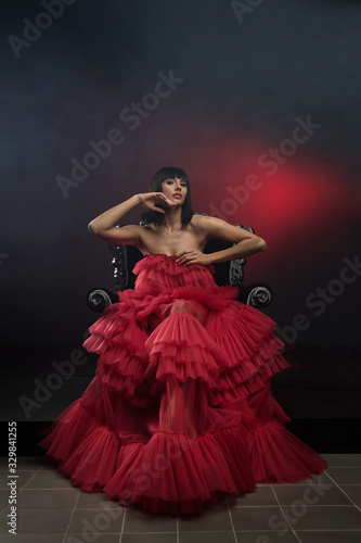 Female model in red dress on chair