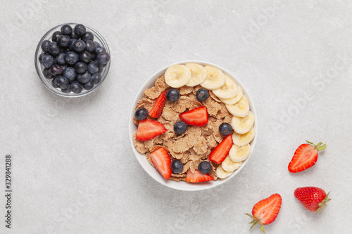 Konstfotografi Multigrain wholewheat healthy cereals with banana and fresh berries blueberry, strawberry for breakfast