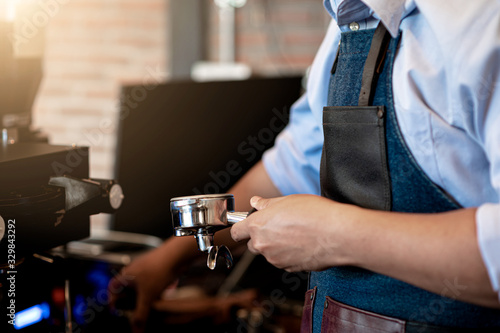 The barista with blue shirt making coffee
