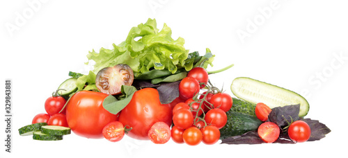 Fresh different red tomatoes  green cucumbers  purple and green basil and sage leaves isolated on white background. Ingredients for vegetable salad