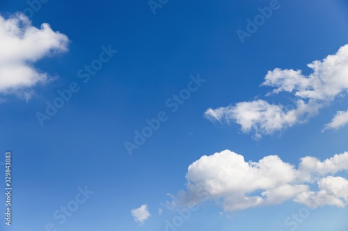 Beautiful white soft fluffy clouds on a blue sky background. Copy space