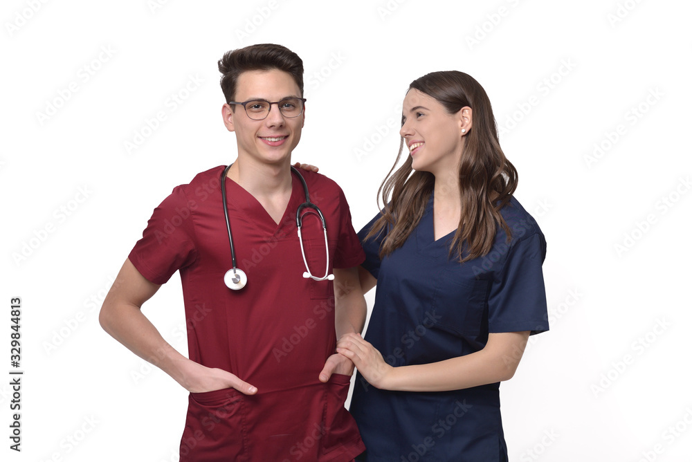 Beautiful young doctor with stethoscope over neck and assistant isolated on white background Beautiful young doctor with stethoscope over neck and assistant isolated on white background