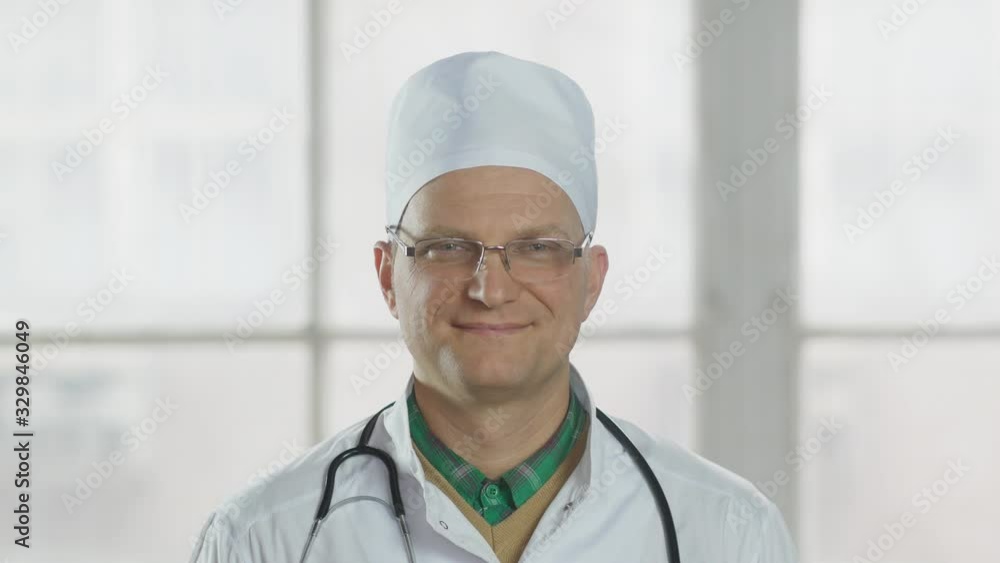 Confident doctor looks at the camera and smiles. Confident doctor looks at the camera and smiles.