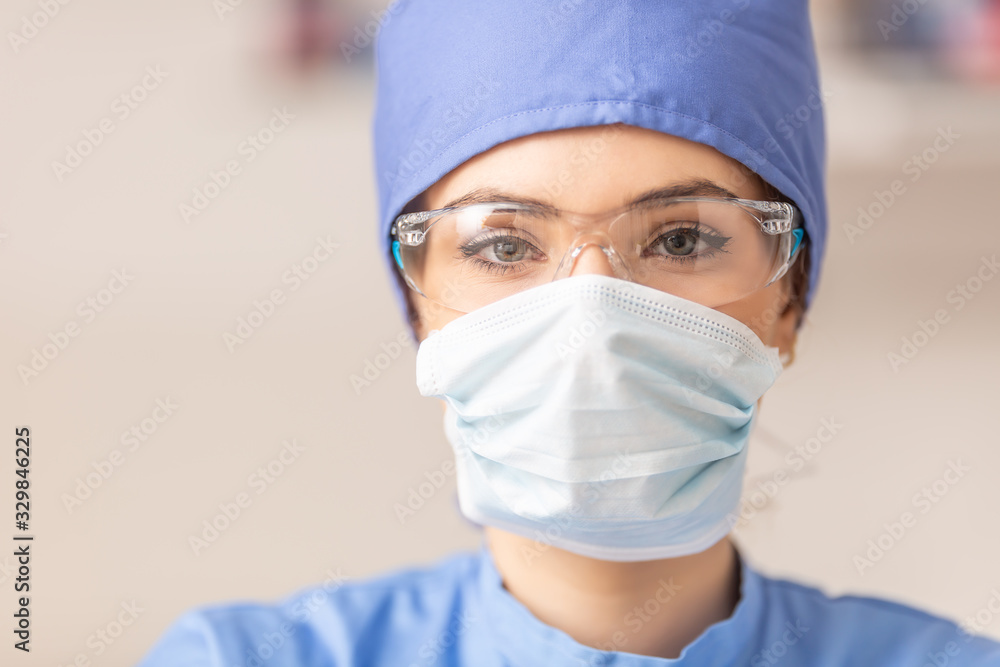 Portrait of female doctor in special surgical sterile protective clothing - obrazy, fototapety, plakaty 