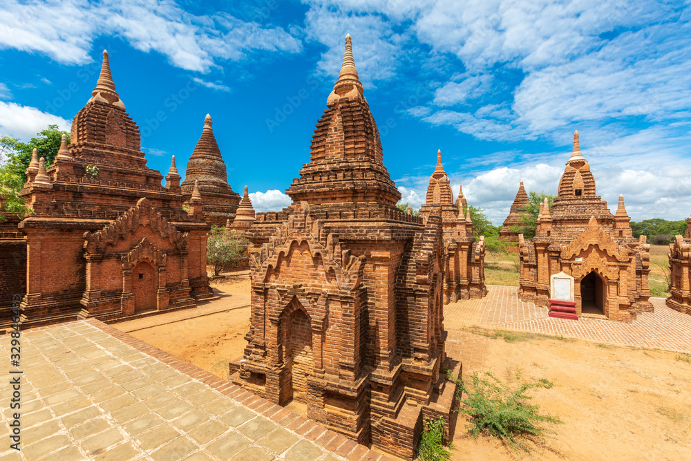 Fototapeta premium Buddhist pagoda temple. Bagan, Myanmar. Home of the largest and denset concentration of religion Buddhist temples, pagodas, stupas and ruins in the world. Blue sky with clouds.