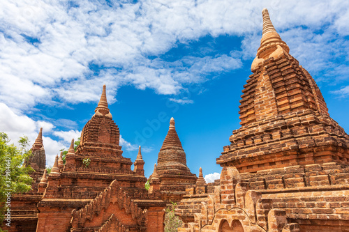 Buddhist pagoda temple. Bagan  Myanmar. Home of the largest and denset concentration of religion Buddhist temples  pagodas  stupas and ruins in the world. Blue sky with clouds.