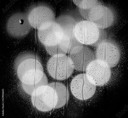 abstract bokeh backdrop with rain water drops on glass window