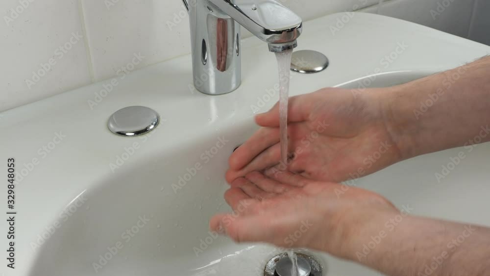 Unrecognisable man washing hands, close up Unrecognisable man washing hands, close up