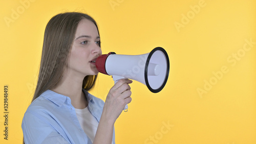 Beautiful Woman Announcing on Loudspeaker, Yellow Background