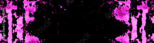 Frame of pink neon painted abstract speckled splashes of color isolated on black background banner panorama