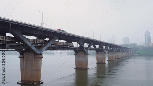 Shot of train moving through Cheongdam Bridge across Han River in Seoul, South Korea photo