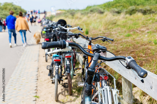 parked bicycles ahead of dunes at the Northern Sea in the Netherlands