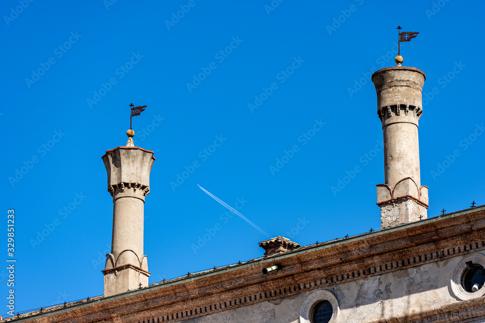 Trento city, close-up of two ancient chimneys on the roof in Venetian style. Castello del Buonconsiglio, Medieval castle. Trentino Alto Adige, Italy, Europe