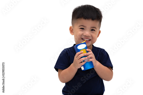 Cute Asian baby little boy holding milk box and sucking milk tube isolated on white background