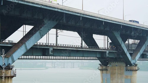 Shot of train moving through Cheongdam Bridge across Han River in Seoul, South Korea photo