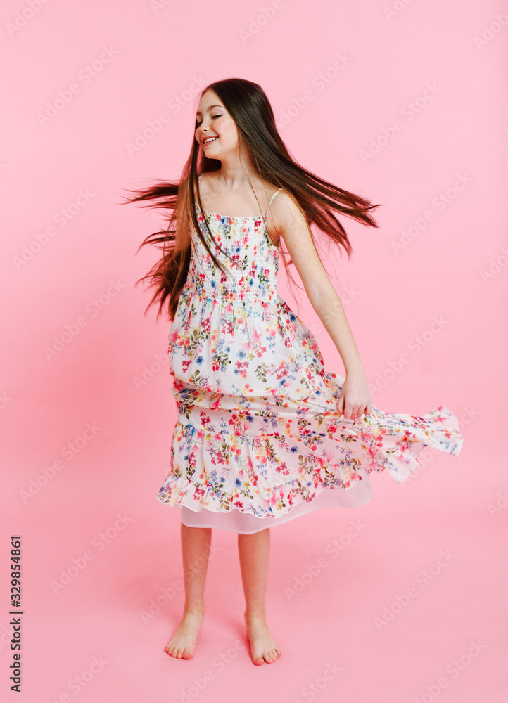 Portrait of adorable smiling little girl child dancing in dress isolated Portrait of adorable smiling little girl child dancing in dress isolated