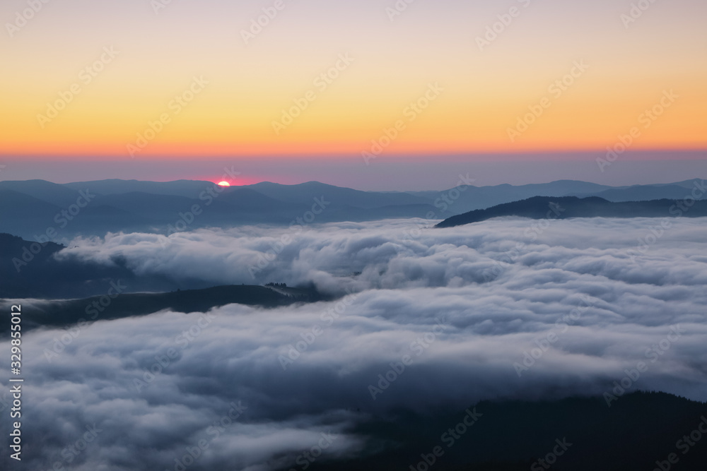Scenery of the sunrise at the high mountains. Dense fog with beautiful light. Location Carpathian mountain, Ukraine, Europe. Magic spring wallpaper. Scenery of the sunrise at the high mountains. Dense fog with beautiful light. Location Carpathian mountain, Ukraine, Europe. Magic spring wallpaper.
