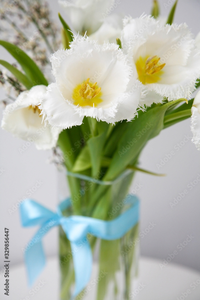Bouquet of white fringed tulips with blue satin bow