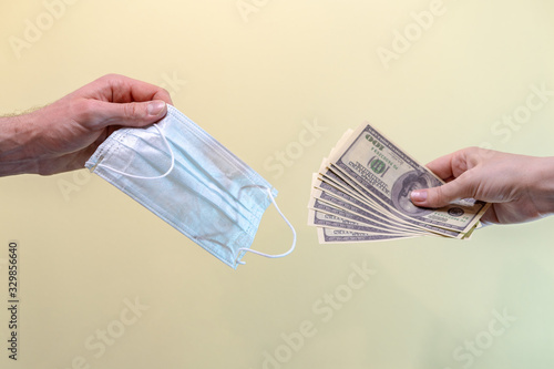 A person buys a medical mask. The high price of masks and the growing demand during quarantine. Concept.