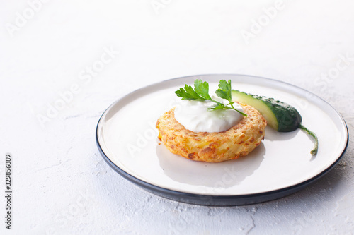 potato pancakes with sour cream , fresh cucumber and herbs