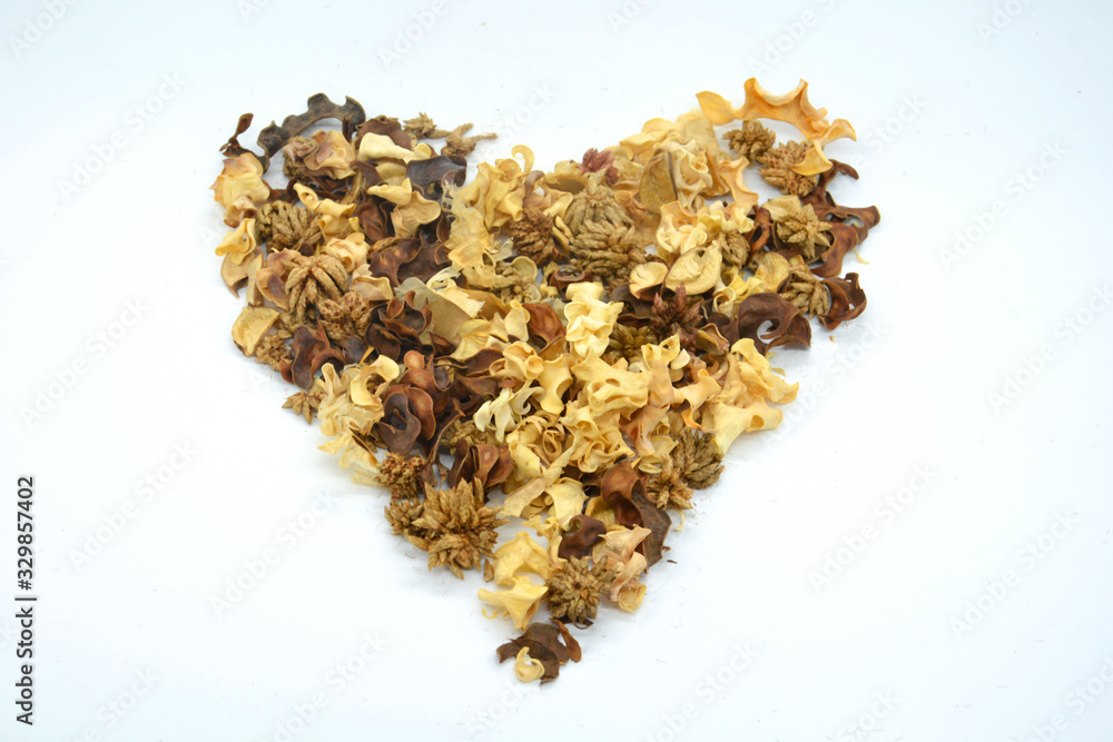 Heart shaped made of dry flowers, leaves and petals on background. Colorful background image. Top view. Flat lay. Copy space. Art concept. Color trends 2020 Heart shaped made of dry flowers, leaves and petals on background. Colorful background image. Top view. Flat lay. Copy space. Art concept. Color trends 2020