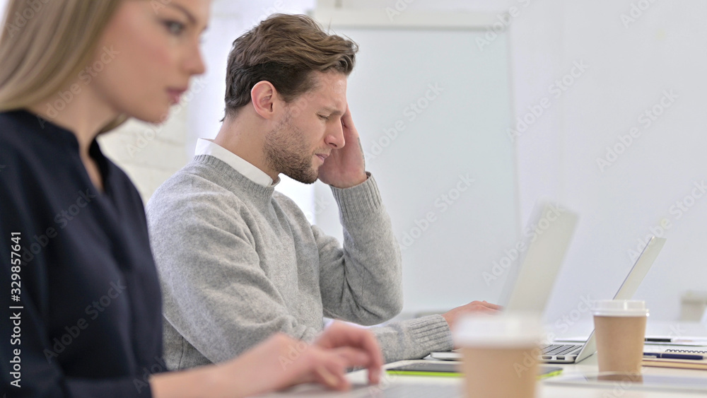 Tired Creative Female Professional having Headache in Office Tired Creative Female Professional having Headache in Office