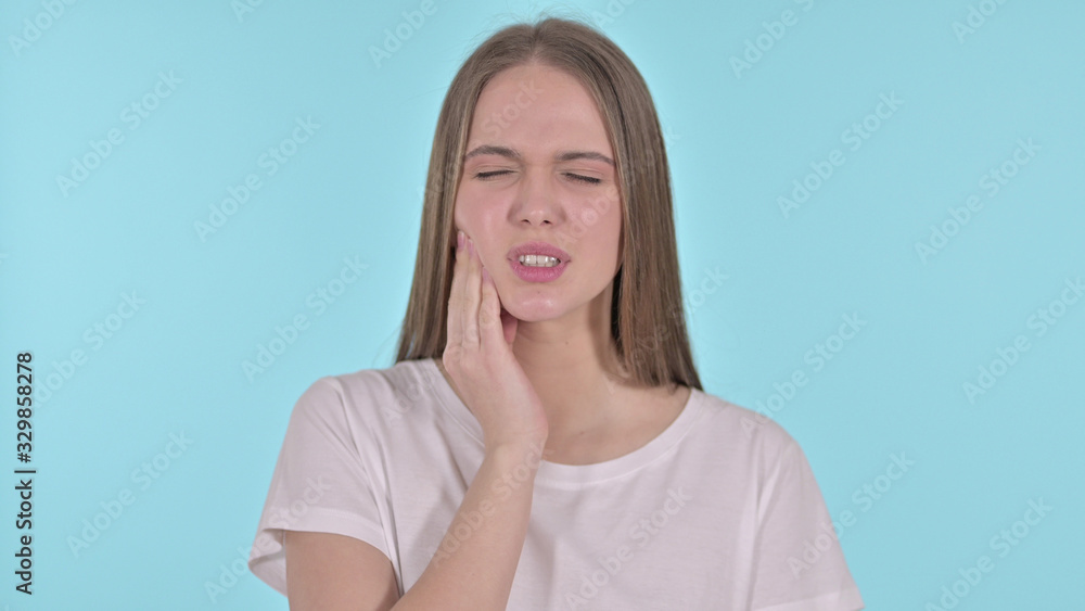 Portrait of Beautiful Young Woman having Toothache, Blue Background Portrait of Beautiful Young Woman having Toothache, Blue Background