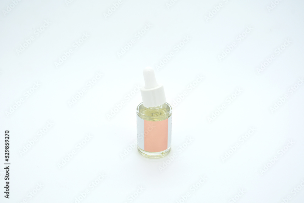 drops of collagen serum moisturizer face in a transparent yellow bottle soft light background. Skin Protector Facial Treatment Essential Oil, Vitamin C. Beauty and Spa Concept.