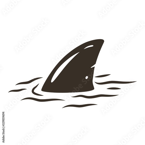 Shark fin in the water with waves