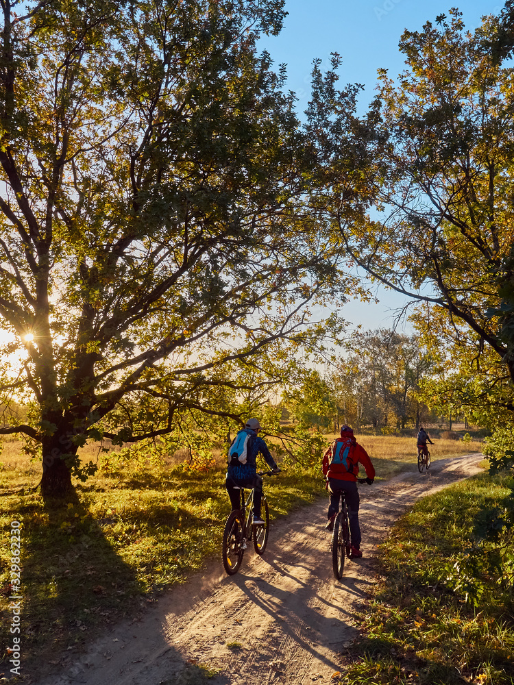 Biking cyclists cycling rides the sunset.