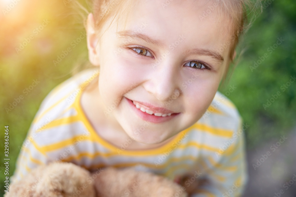 Portrait of cute smiling little child girl with at the park in summer Portrait of cute smiling little child girl with at the park in summer