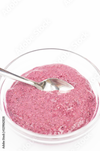 Smoothie made of blackberries in the bowl with spoon