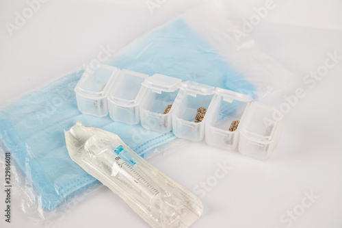 medical mask  syringes and pills on a white background. treatment of the disease and the virus. coronavirus