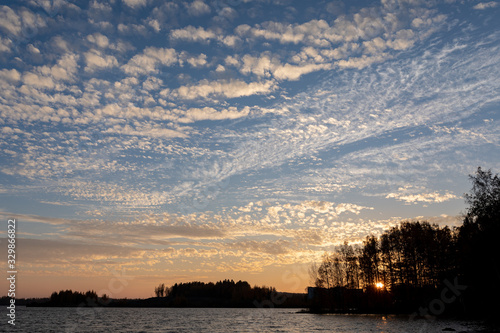 Cirrocumulus clouds sunset sky landscape © Juhku