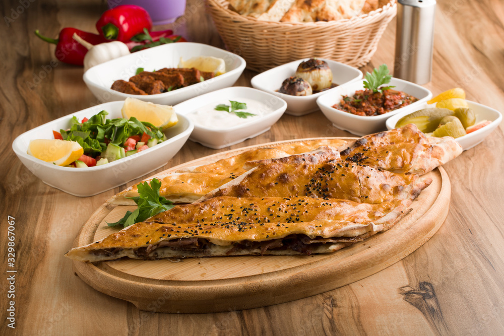closed mince turkish pide on wooden table closed mince turkish pide on wooden table