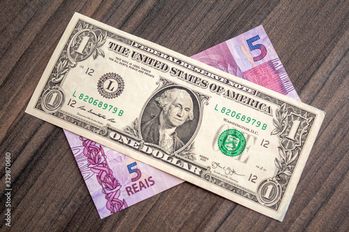 US dollar bill and Brazilian reais banknotes, business finance exchange market