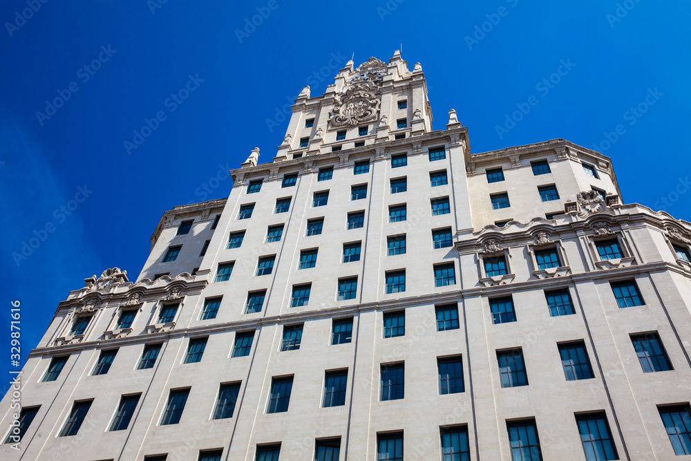 Beautiful architecture of the antique buildings located at Gran via street in Madrid