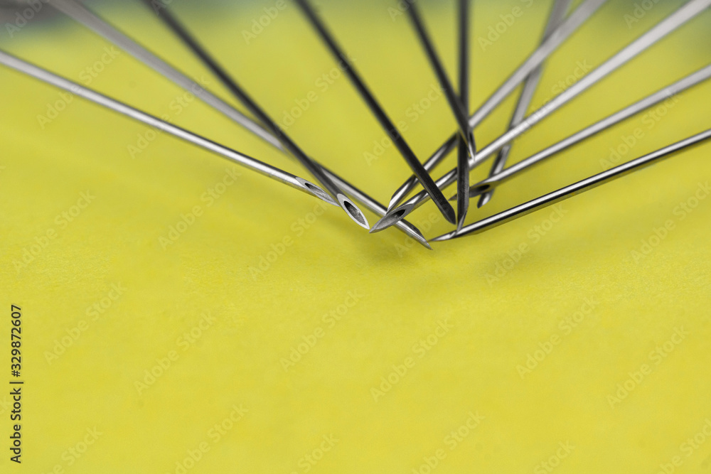 Fototapeta premium a lot of syringes lying next to each other on a yellow background. Vaccination, doping, drugs