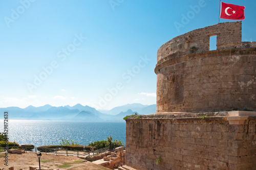 Flag of Turkey above the Hidirlik Tower, Karaalioglu Park in the historic town Kaleici, Antalya, Turkey photo